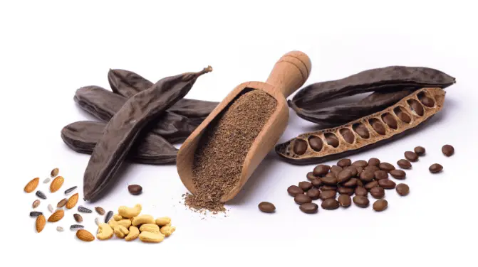 Photo of scattered carob pods and other nuts