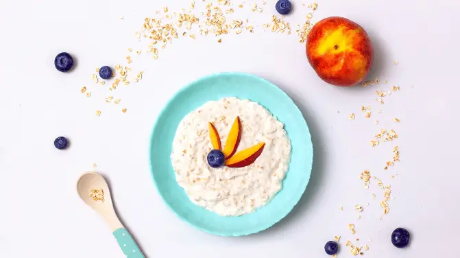 Photo of oats with milk or breast milk in a blue bowl